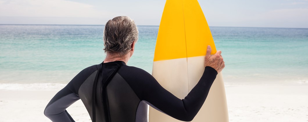 Higos Man holding surfboard on the beach Personal insurance