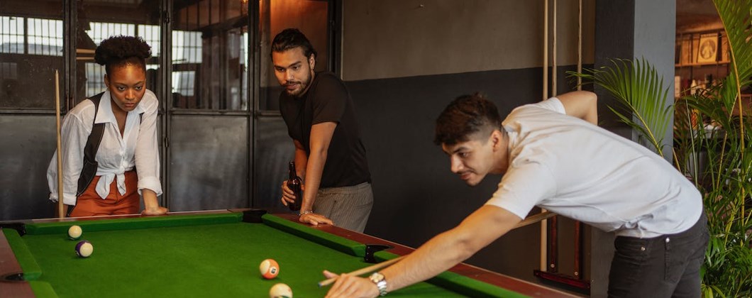 Friends playing snooker in a social club.